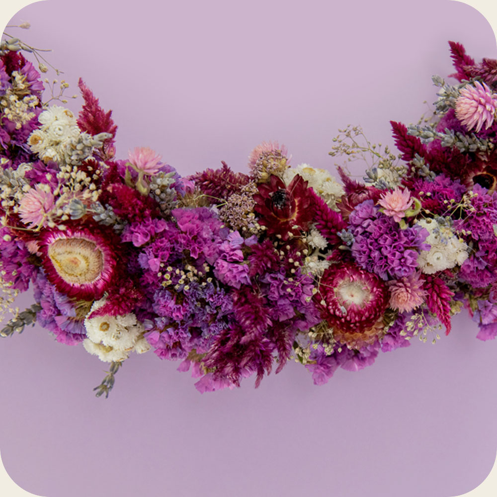 Close Up of Dried floral wreath Pink & purple dried flower wreath. Gorgeous handmade berry toned floral wall decor