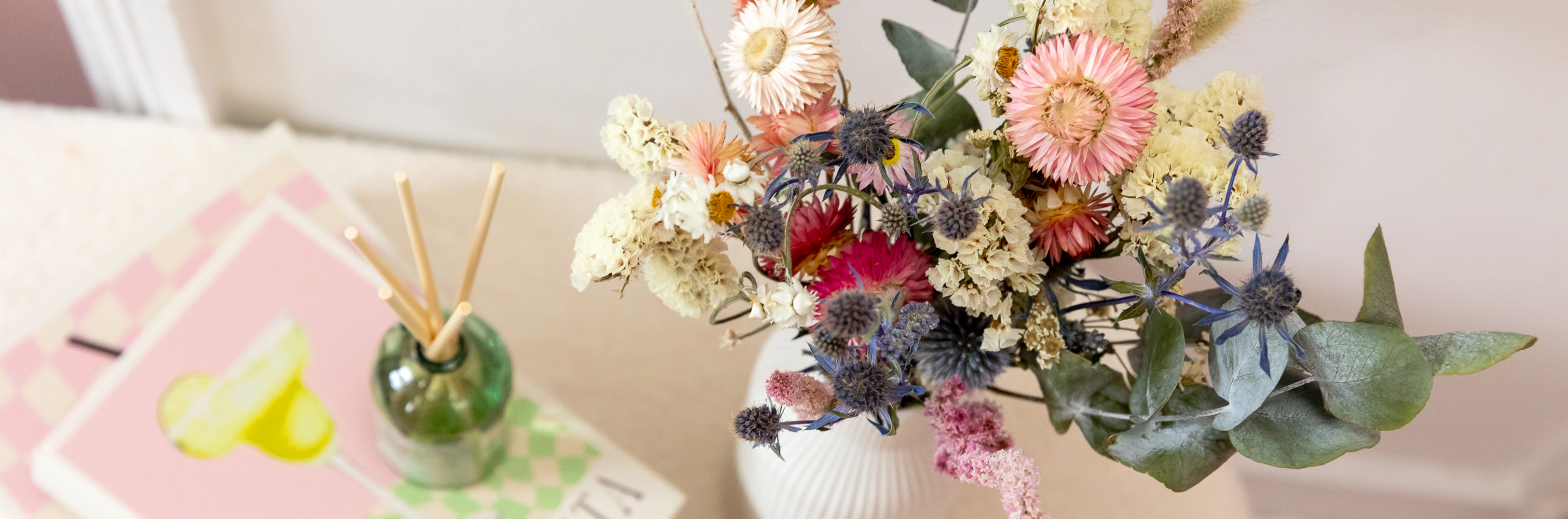 Stunning bouquet of dried flowers in a vase on a table. Perfect home décor. Pastel pinks, greens and blues. Luxury stylish home dried floral arrangement