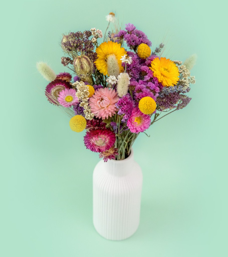 Birthday flower gifts banner. Bright and colourful dried flowers in a vase. Flores and Bloom